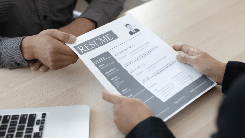 Employer checking applicant's resume during interview