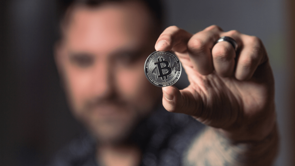 a person holding a crypto coin