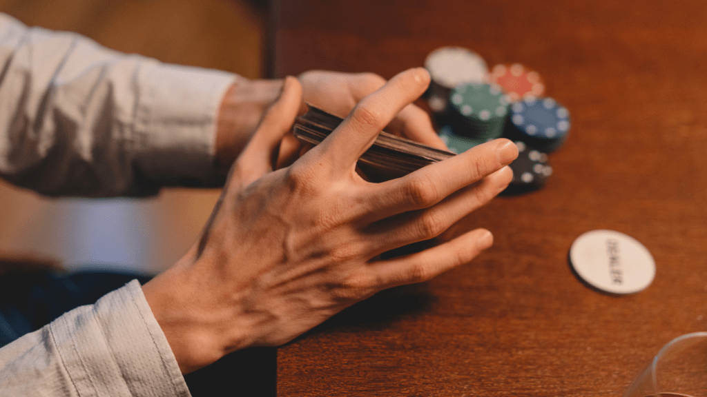 a person holding a casino playing cards