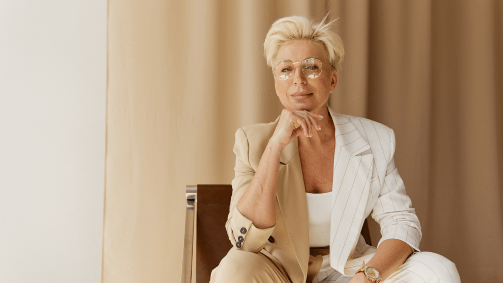 A woman sitting wearing a business attire