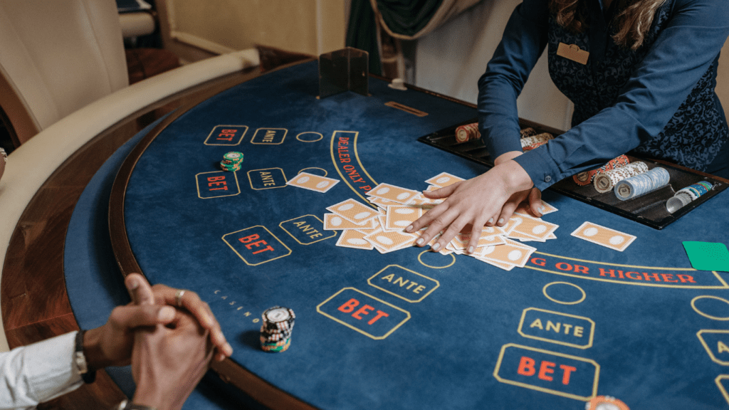 a casino table with several people playing blackjack