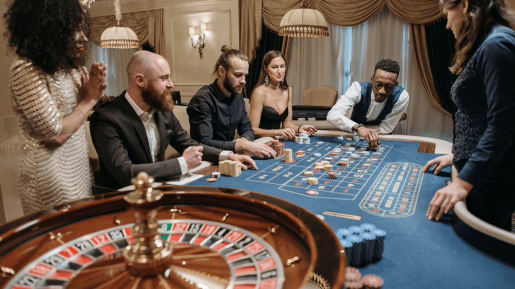 a group of people playing roulette in a casino