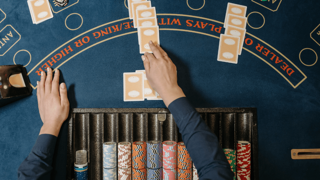 a person holding a casino playing cards